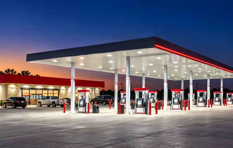 Brightly lit Dairy Mart style gas station at dusk