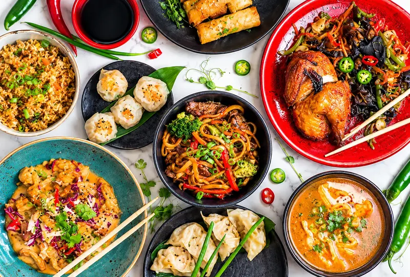 Overhead view of hot Asian food and dumplings
