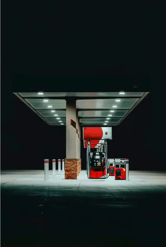 Gas pumps under a dramatic night canopy